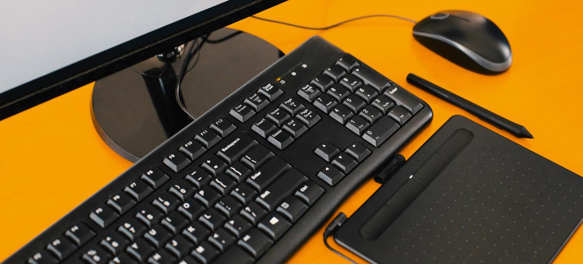 PC device, keyboard and mouse on yellow background
