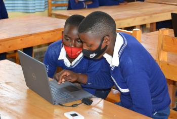 Two children using a laptop.