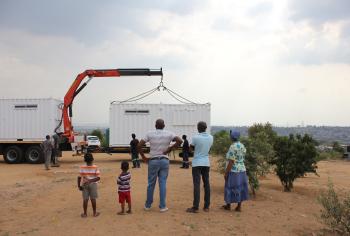 People stand looking at a Solar Learning Lab