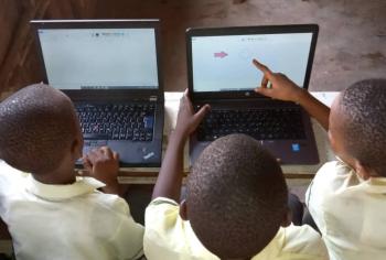 Three students using laptops
