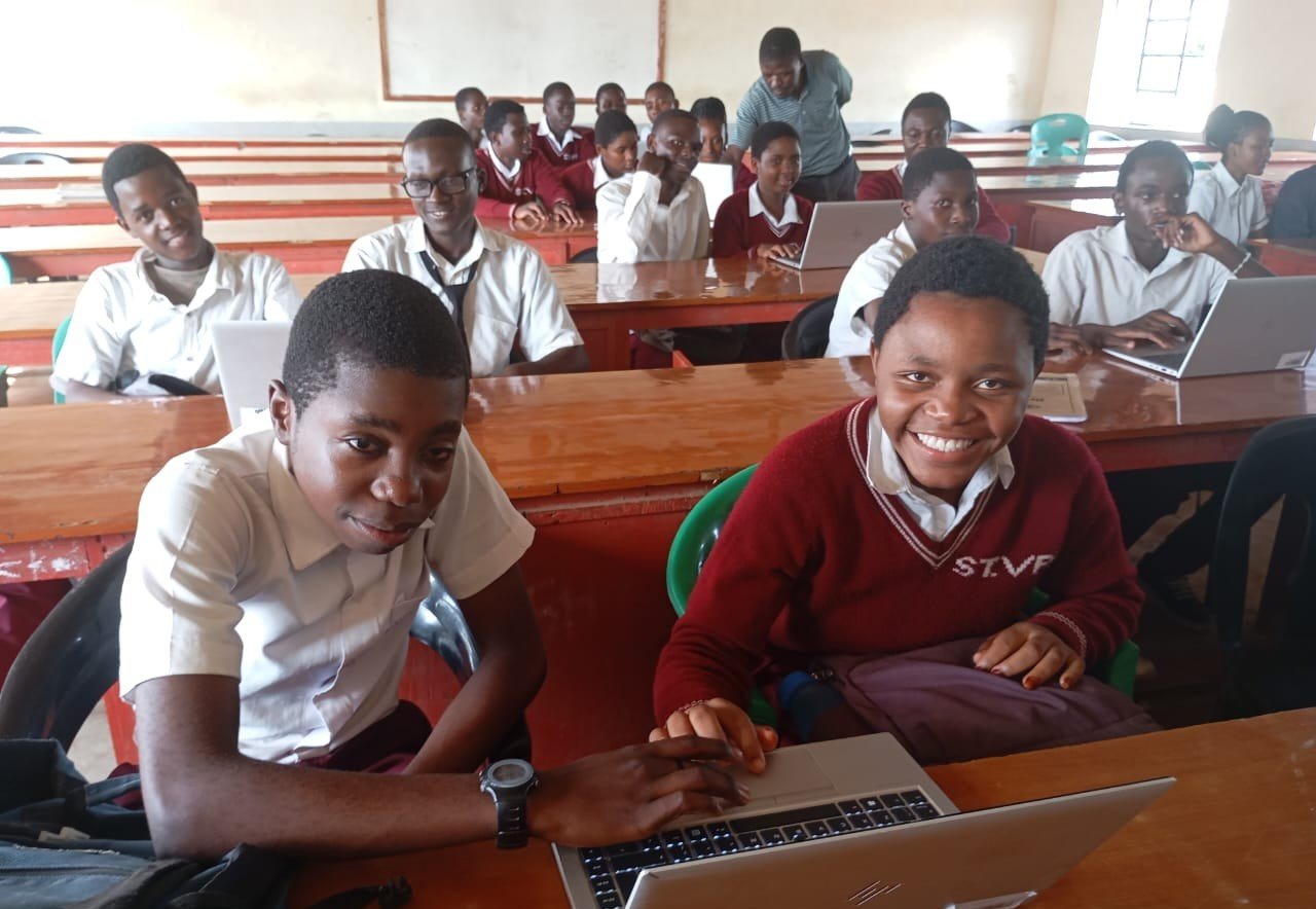 students in class using laptops